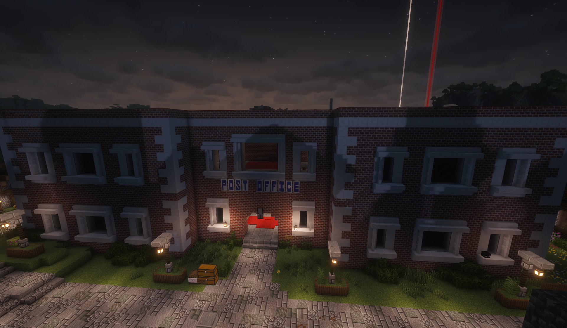 Night view of the brick post office with a lit entrance in the shopping district
