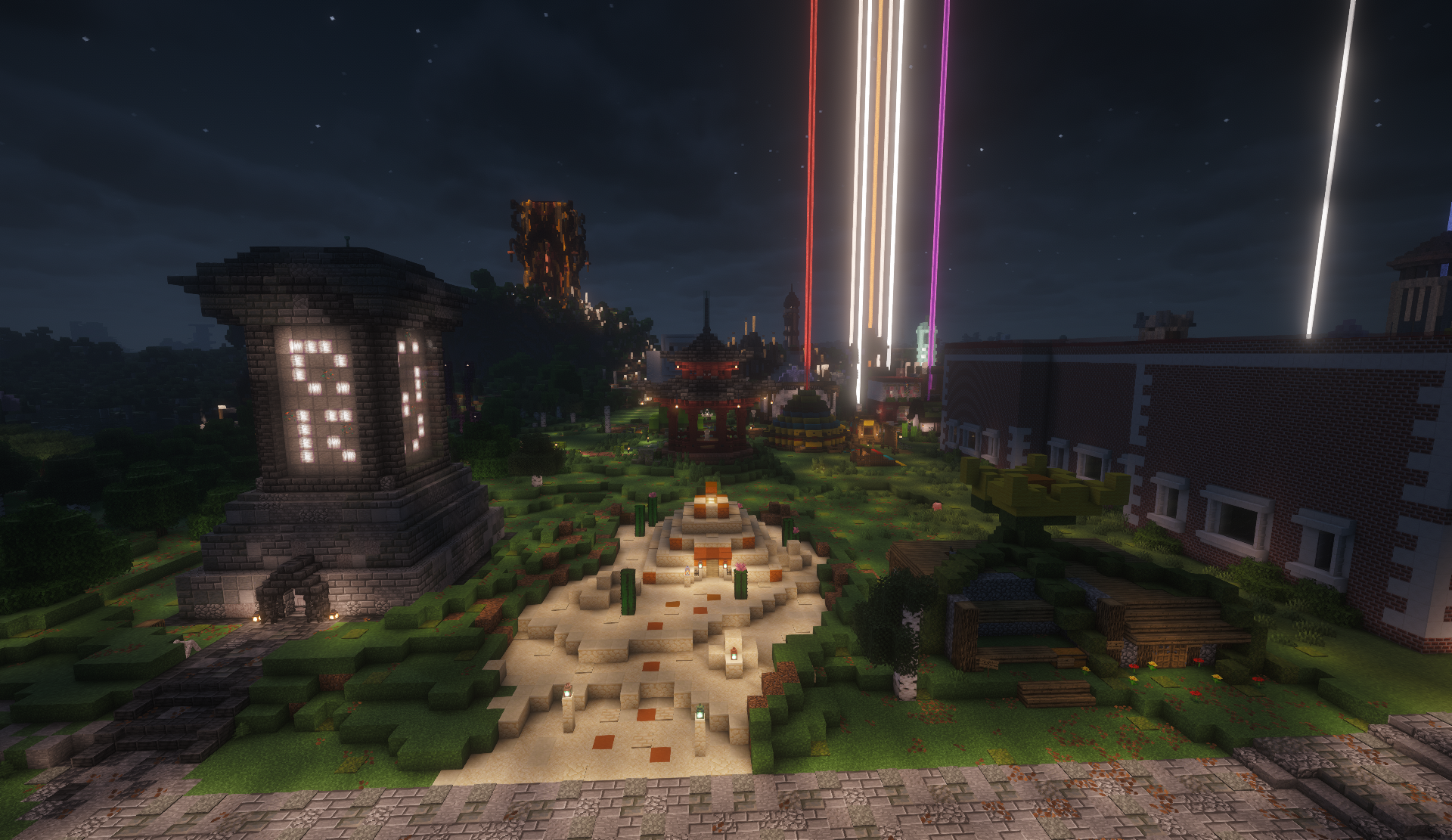Stone monument with glowing letters beside a sandy plaza in the shopping district