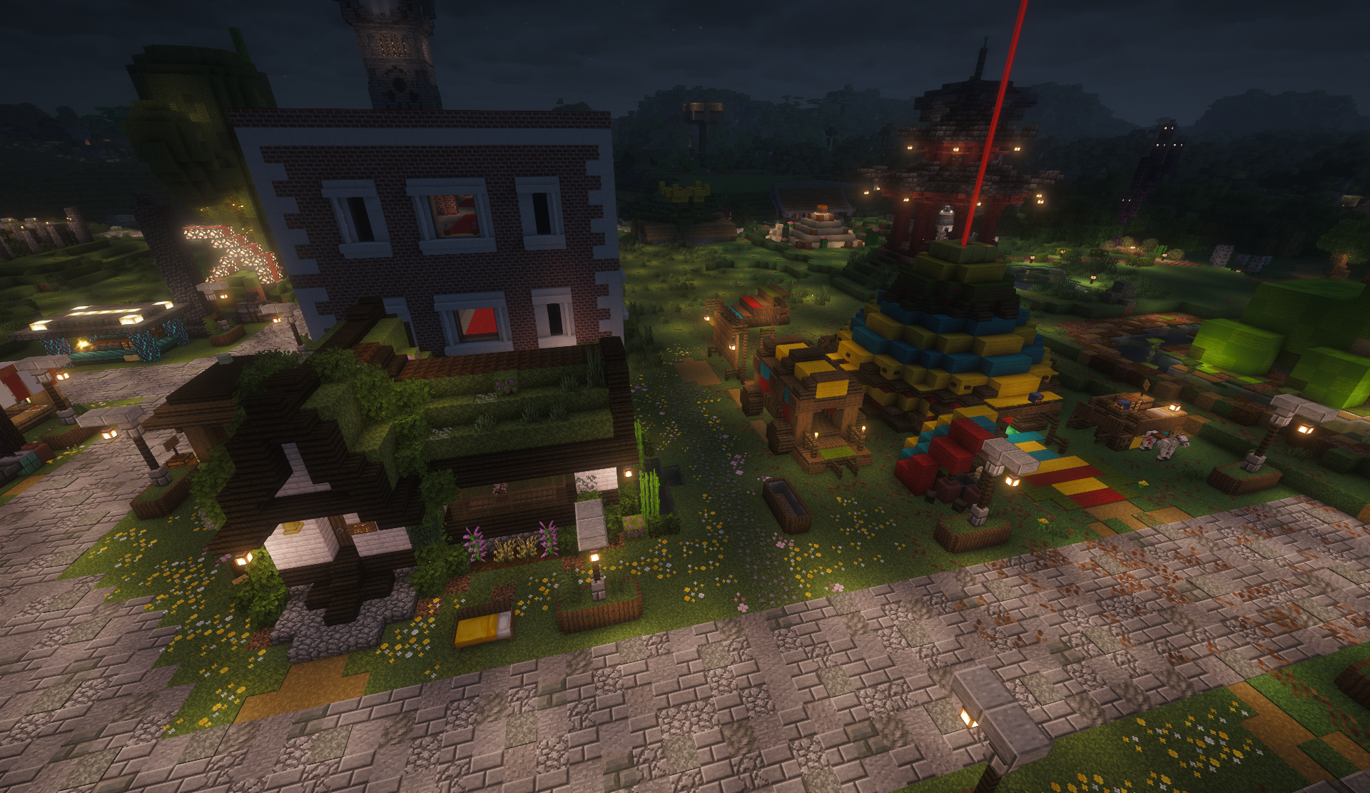 Brick townhouse, grass-roof cottage, and colorful stacked shop at night