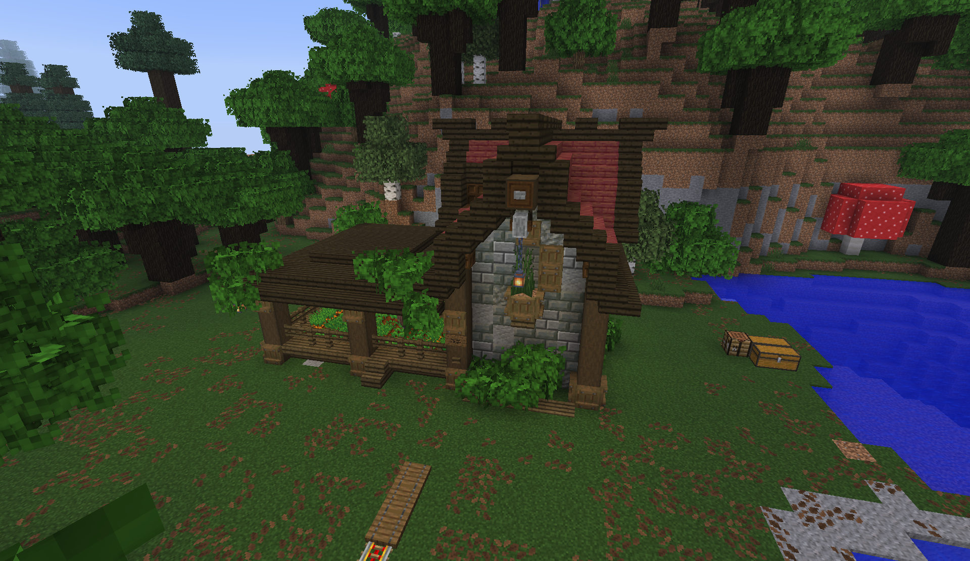 Medieval cottage with stone walls and a red roof beside a forest lake