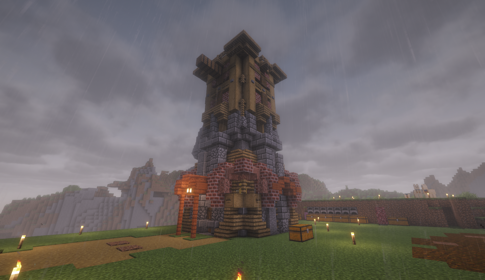 Tall multi-tiered tower on a rainy hillside with furnaces nearby