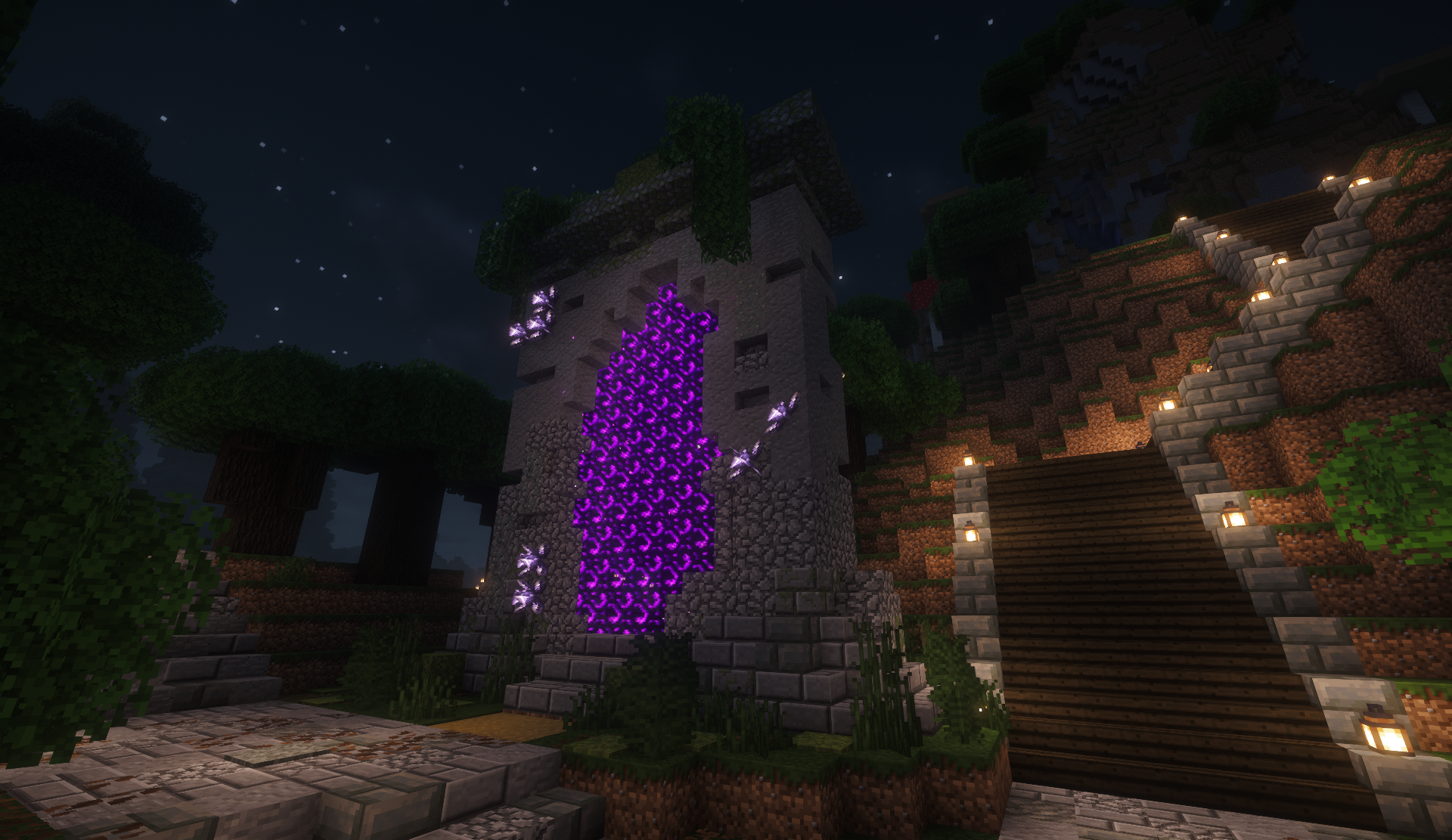 Custom nether portal framed in stone with a lantern-lit staircase