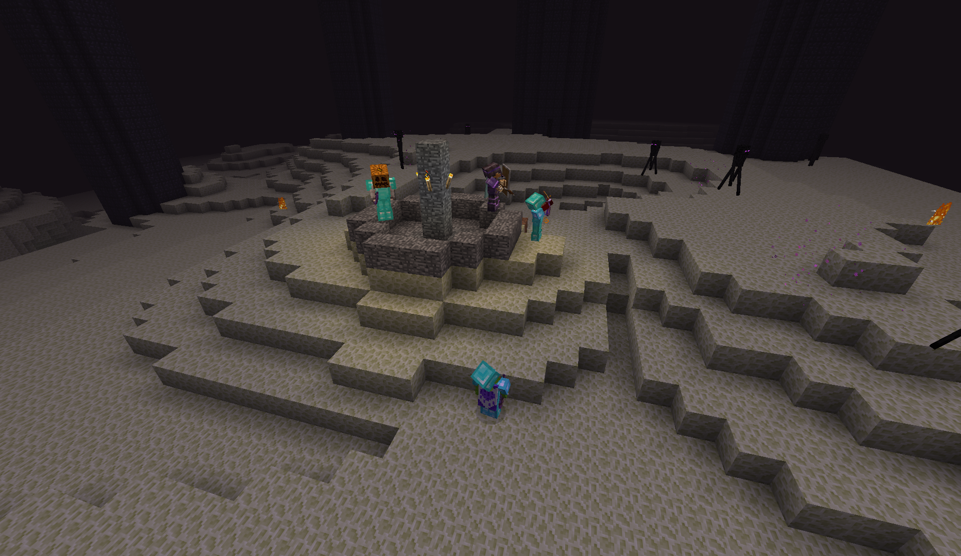 Players on the End island before the dragon fight, with Endermen in the distance