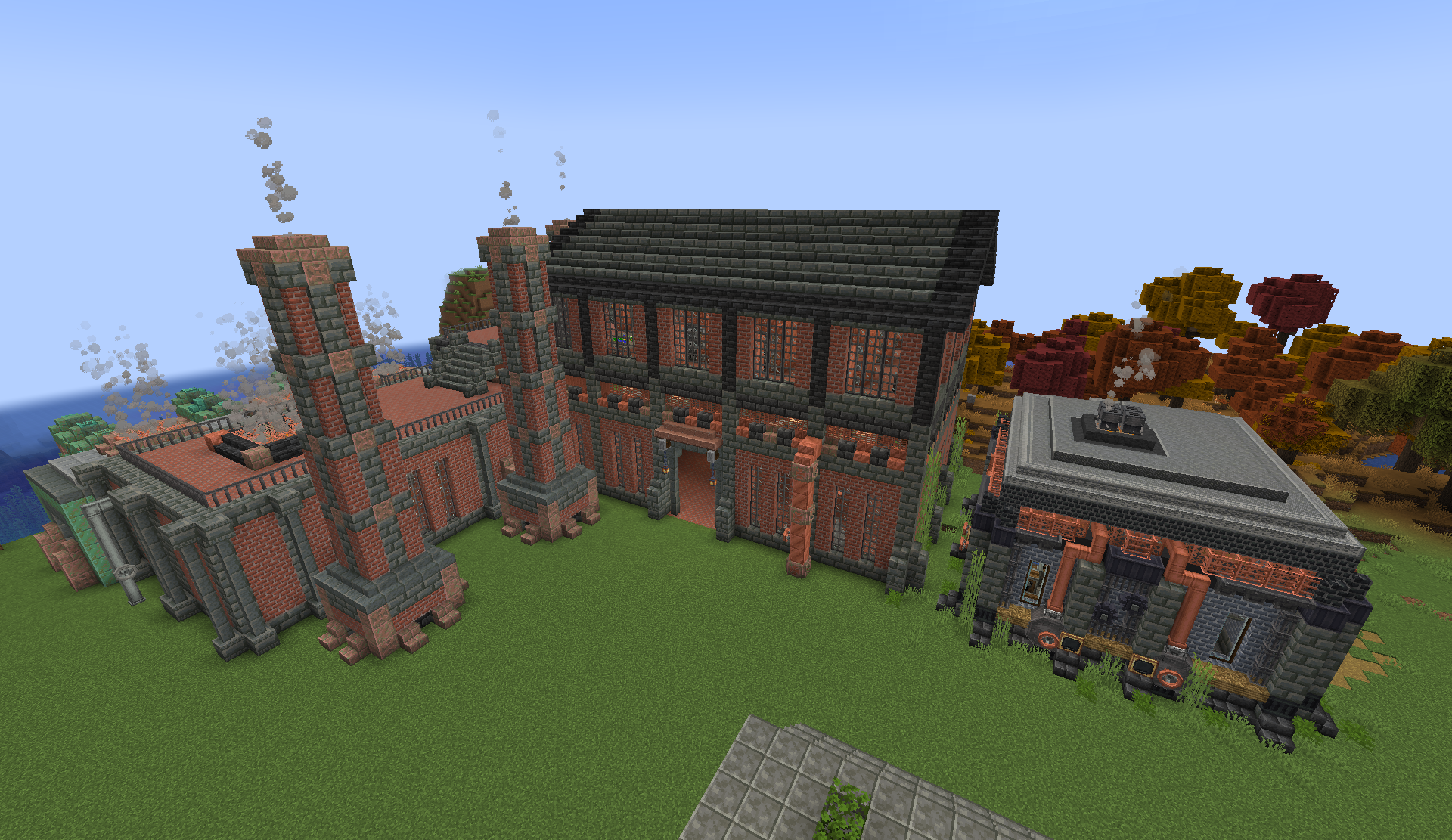 Brick factory with smokestacks and a smaller industrial annex on a grassy plot