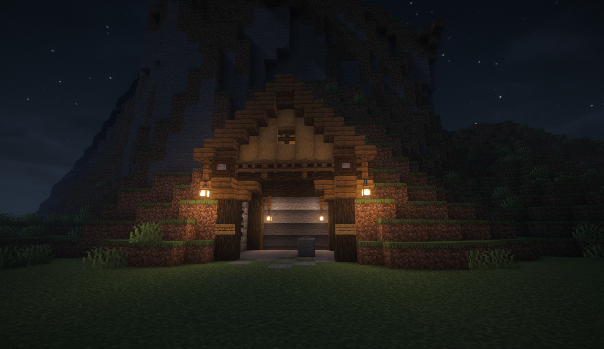 Community Mine entrance built into a hillside, lit by hanging lanterns